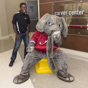 Handshake hand chair with Big Al and Career Center student staff